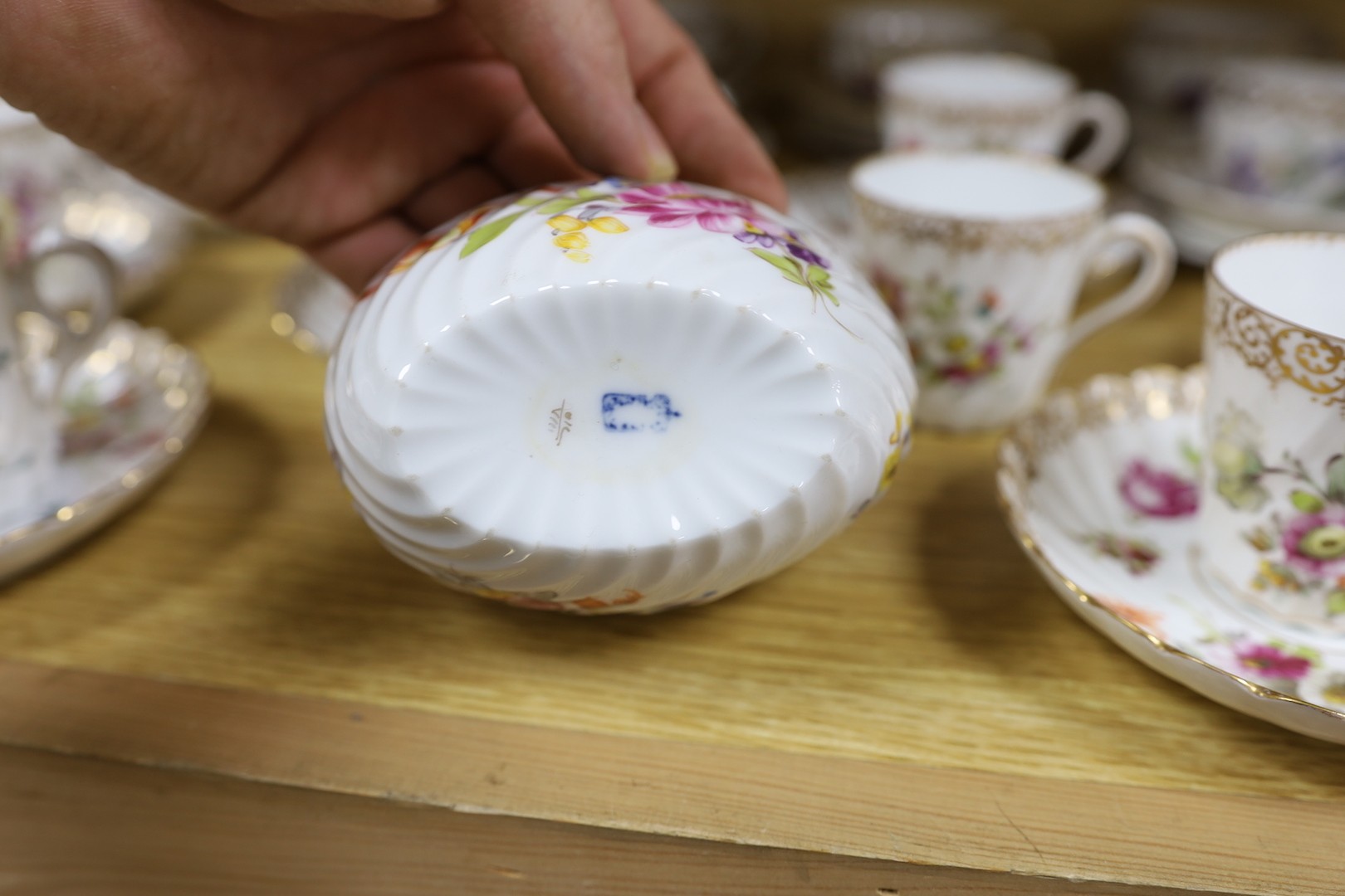 A quantity of Nymphenburg and Dresden porcelain cups and saucers